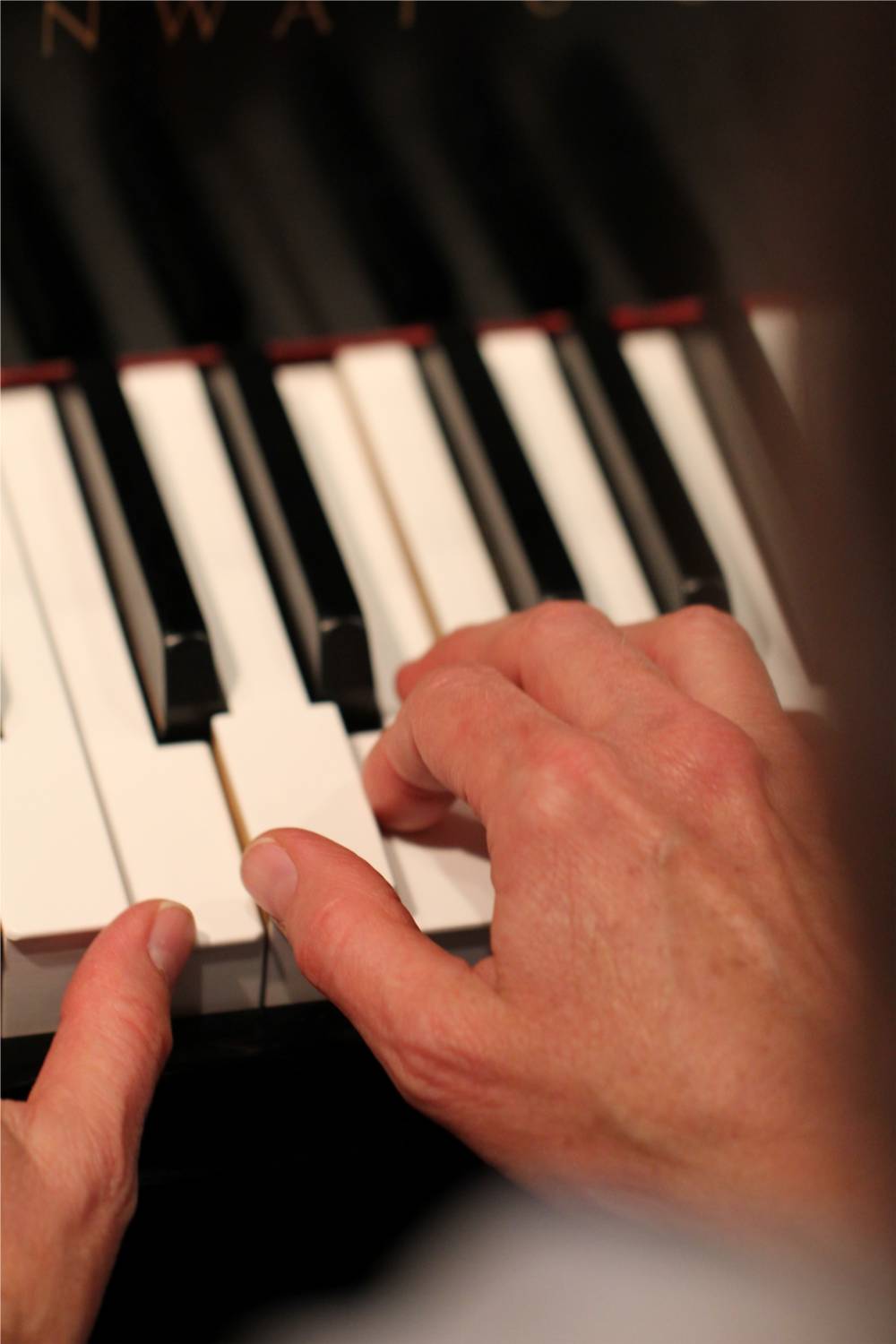 Piano teacher Winifred Kerner's hands while playing the piano.