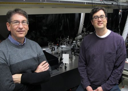 Andrew Marcus and Mark Lonergan stand by spectroscopy equipment