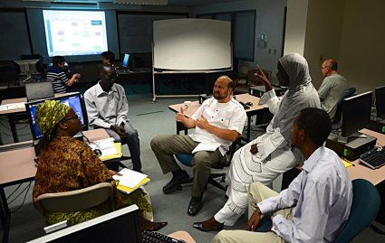 Steve Huter, center, of the NSRC leads a group discussion