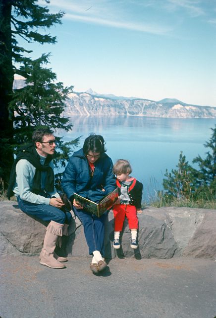 16. In August of 1967 they moved to Eugene. Here she is at Crater Lake reading to Emily, with her younger brother David by her side.