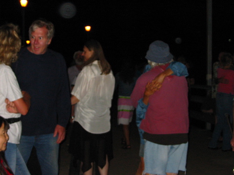 Rebecca Oswald (center, back to camera), in elegant black and white