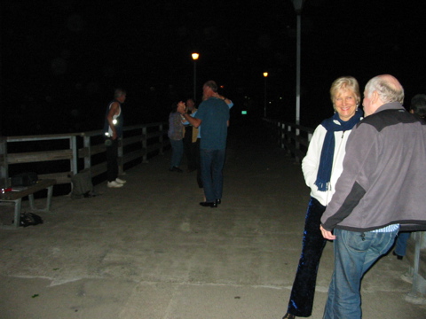 7:44PM: Drew talking with another lovely tanguera while Jack's still dancing with Irene, and Steve watching, while Zydequero David is trying out tango